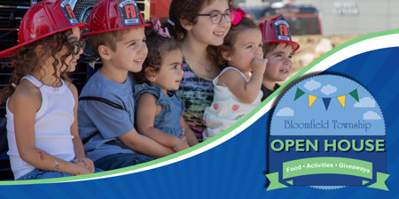 Kids wearing Fire helmets posing on the front bumper of a fire truck with logo for Bloomfield Township Open House with food, activities, and giveaways.