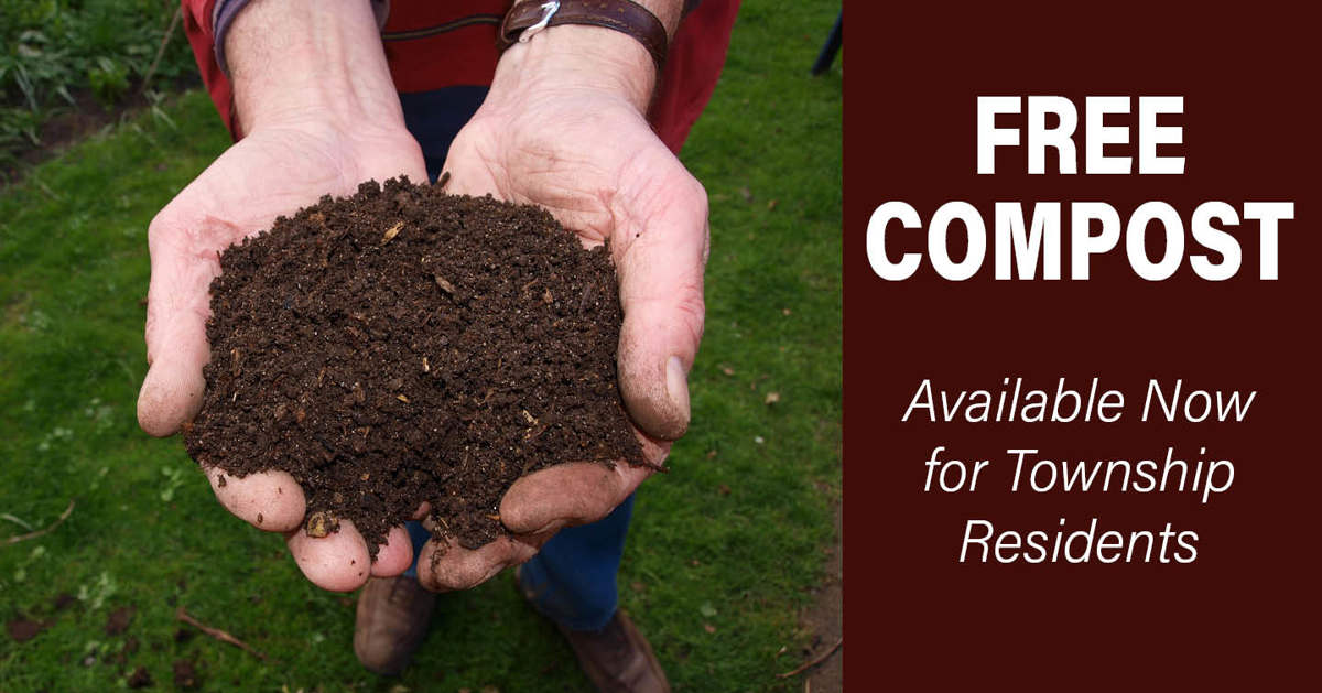 Hands holding dirt with the words "free compost" to the right. 