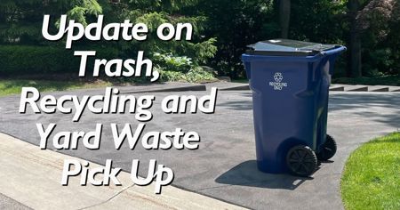 A blue recycling cart at the end of someone's driveway with message: Update on Trash, Recycling and Yard Waste Pick Up