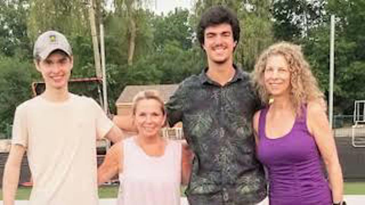 Two men and two women standing next to each other. 
