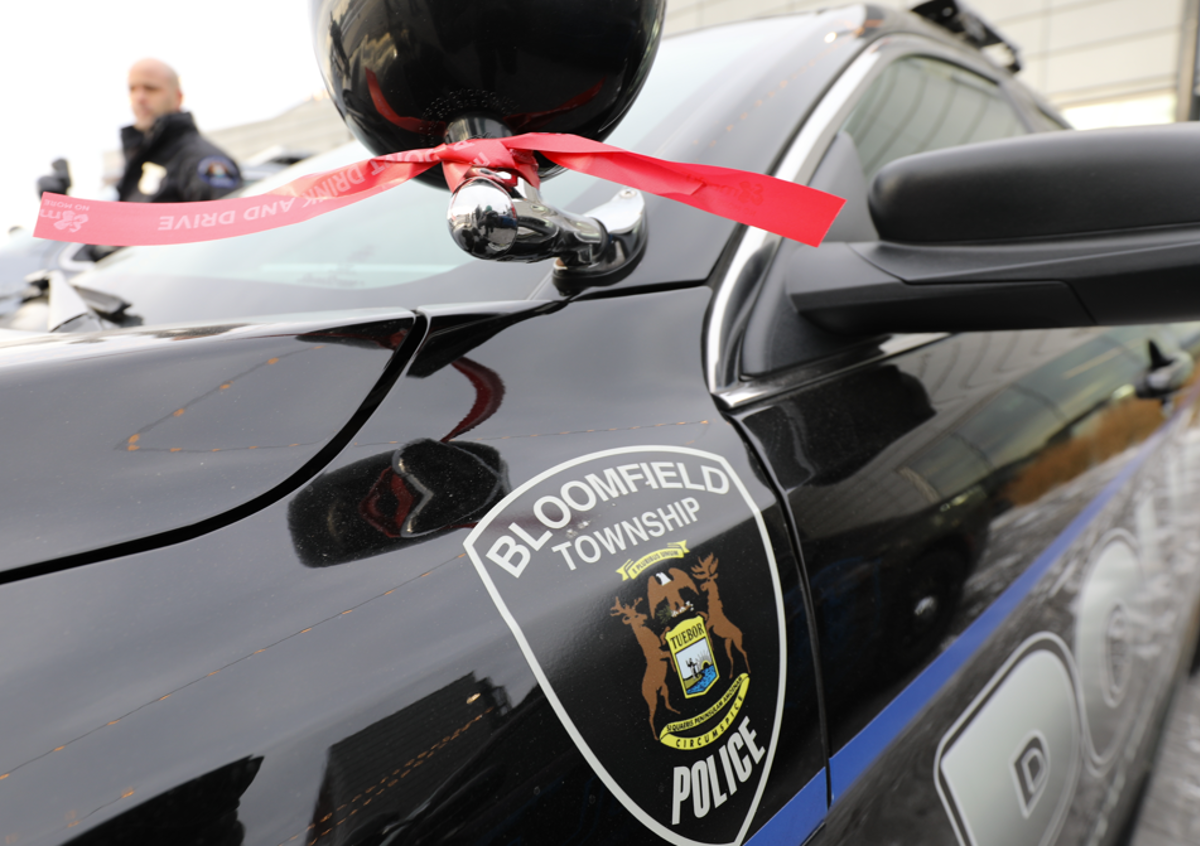 Red ribbon tied around the spotlight of a Bloomfield Township police car. 